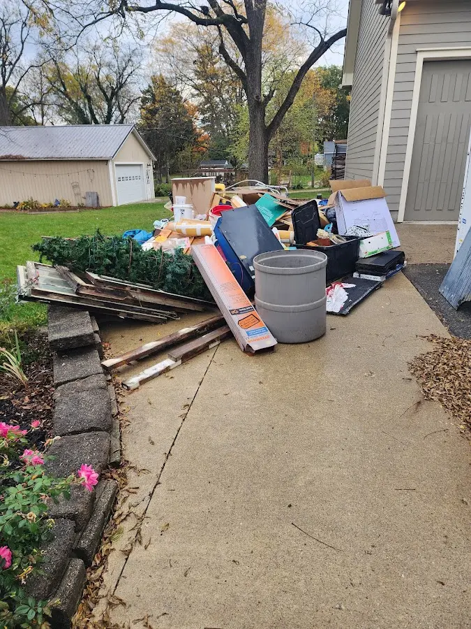 Dumpster being loaded with debris for 10 Yard Dumpster Rental in Bonney Lake